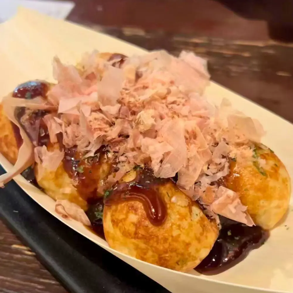 Octopus balls with sauce and bonito flakes at SAKURA, a Asian-Restaurant in Ludlow